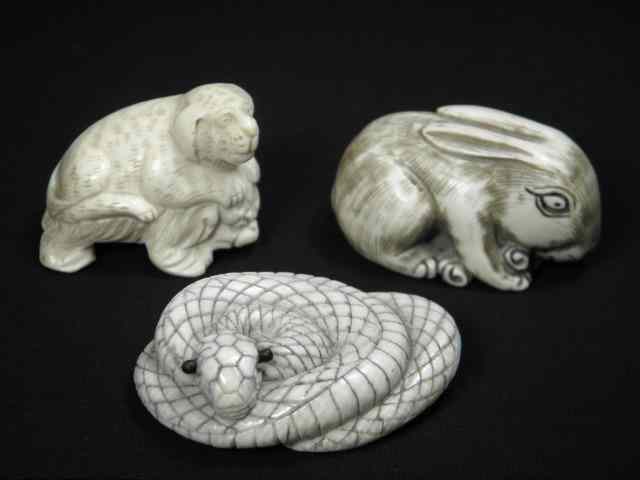 Appraisal: Three Japanese carved ivory netsukes Includes a coiled snake a