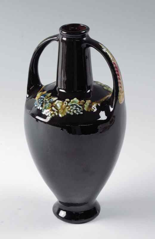 Appraisal: PETERS REED DOUBLE HANDLE VASE Darkest brown glaze with raised