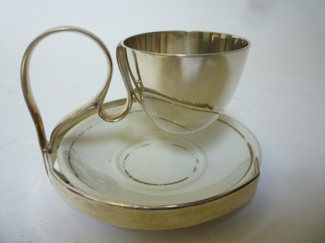 Appraisal: AN EGG CUP maker Hukin Heath probably designed by Christopher