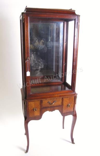 Appraisal: A French style vitrine on legs one drawer and two