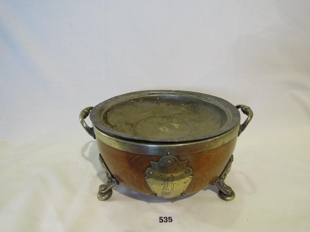 Appraisal: An oak fruit bowl with brass rim raised on cabriole