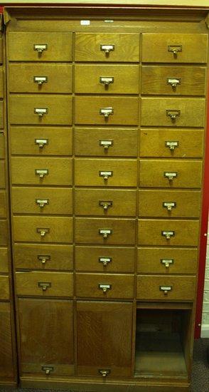 Appraisal: An oak filing cabinet fitted nine rows of three short