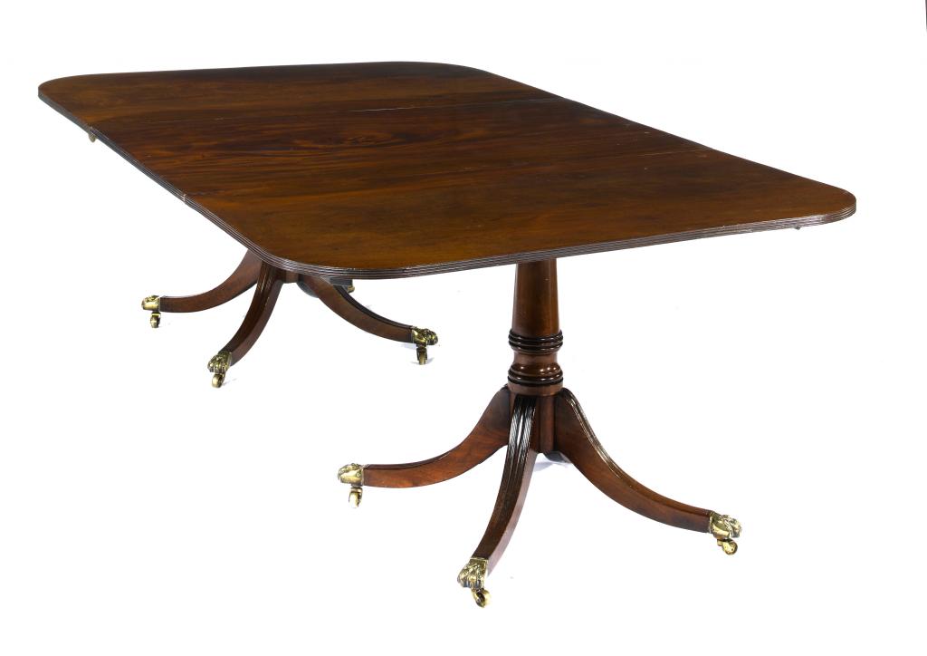 Appraisal: A MAHOGANY TWIN-PILLAR DINING TABLE the well figured top with