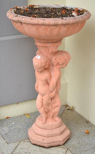 Appraisal: URN SHAPED BIRD BATH SUPPORTED BY THREE ENTWINED CHERUBS