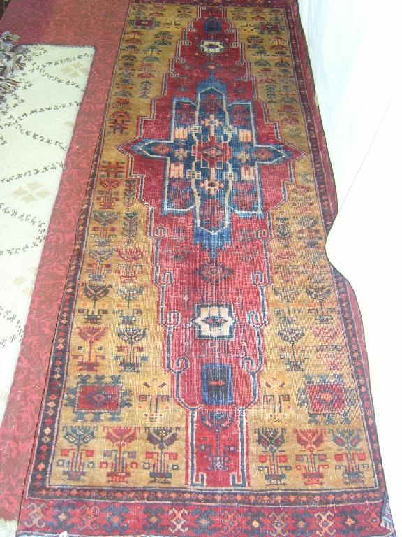 Appraisal: An eastern wool runner with stylised decoration in red blue