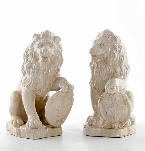 Appraisal: Pair ceramic figures of lions rampant with paw resting on