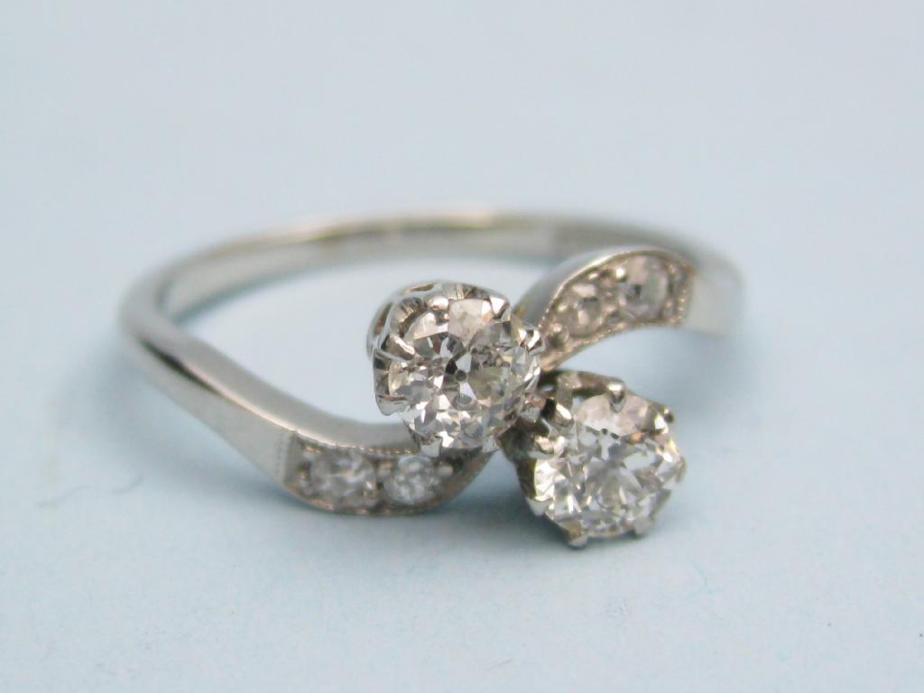 Appraisal: A two stone Diamond Crossover Ring the principle circular-cut stones