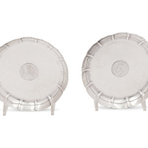 Appraisal: A Pair of Edwardian Silver Coin-Inset Dishes Sebastian Garrard London