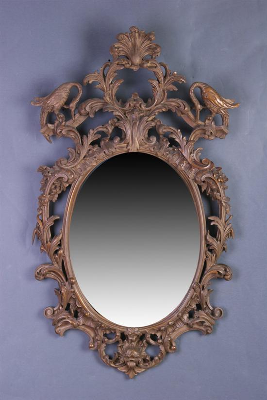 Appraisal: ENGLISH ROCOCO-STYLE CARVED GILTWOOD LOOKING GLASS th century Openwork crested