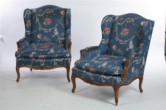 Appraisal: TWO MATCHING WINGBACK CHAIRS Carved finger arms and cabriole legs