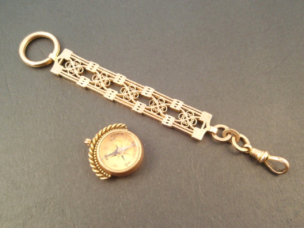 Appraisal: A yellow metal ornate watch suspender g together with a