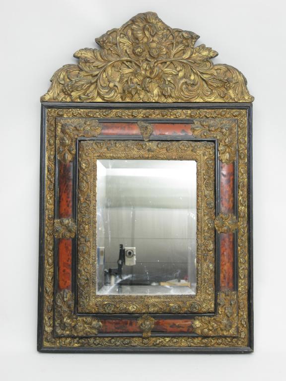 Appraisal: An antique brass mounted tortoiseshell framed Cushion Mirror with bevelled