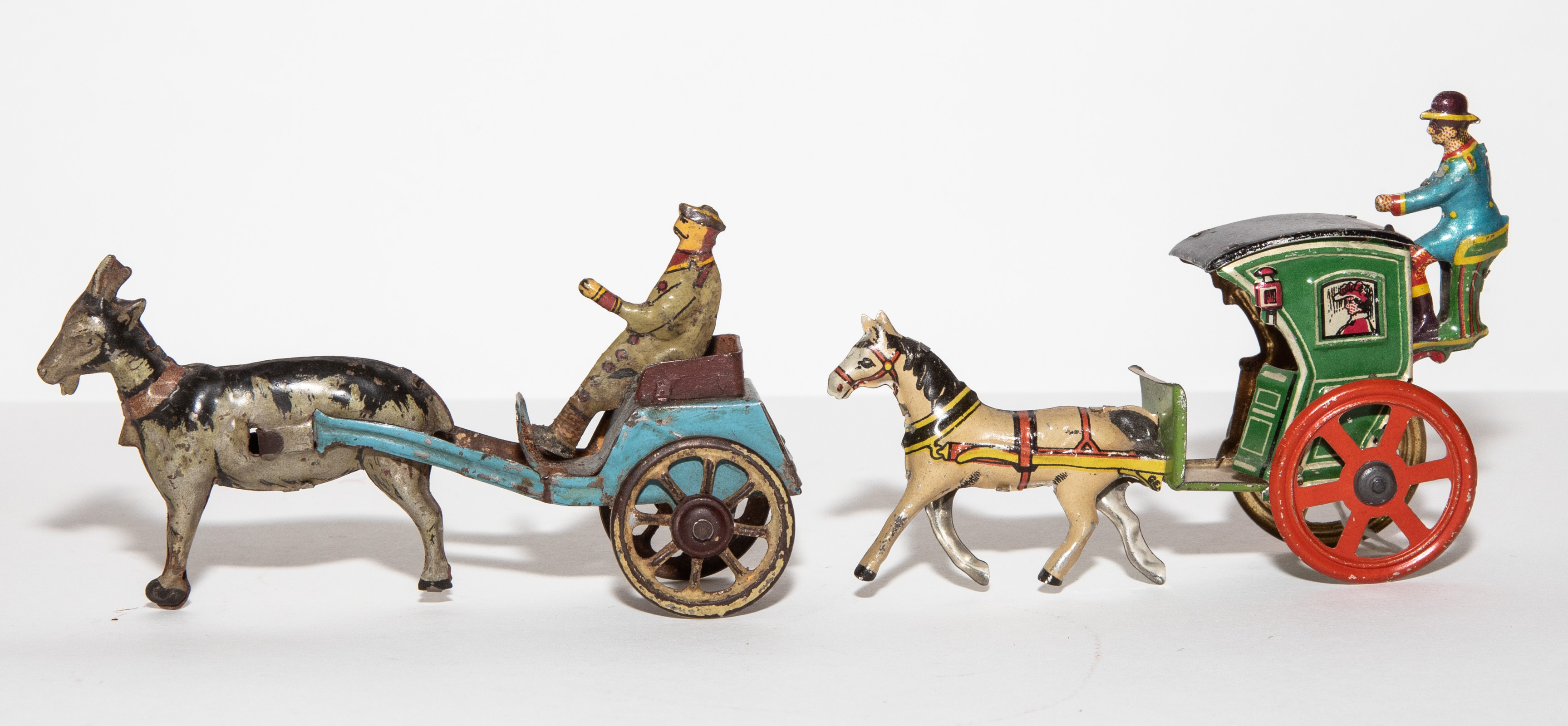 Appraisal: TWO GERMAN PENNY TOY ANIMAL DRAWN CARTS Early th century