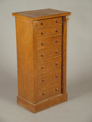 Appraisal: An oak Wellington chest late th century of seven drawers