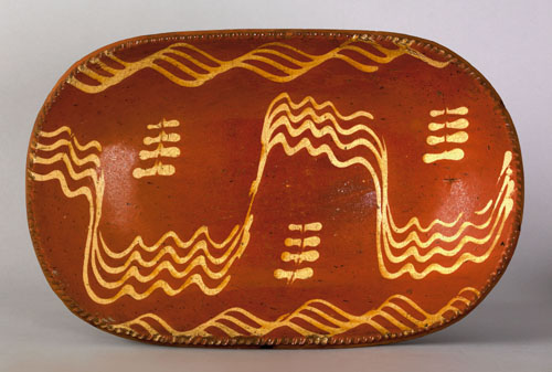 Appraisal: Pennsylvania redware loaf dish th c with a yellow slip