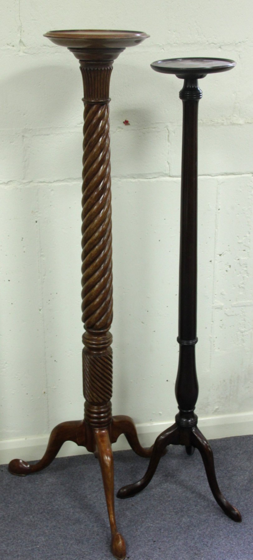 Appraisal: A mahogany torch re on a reeded spiral column and