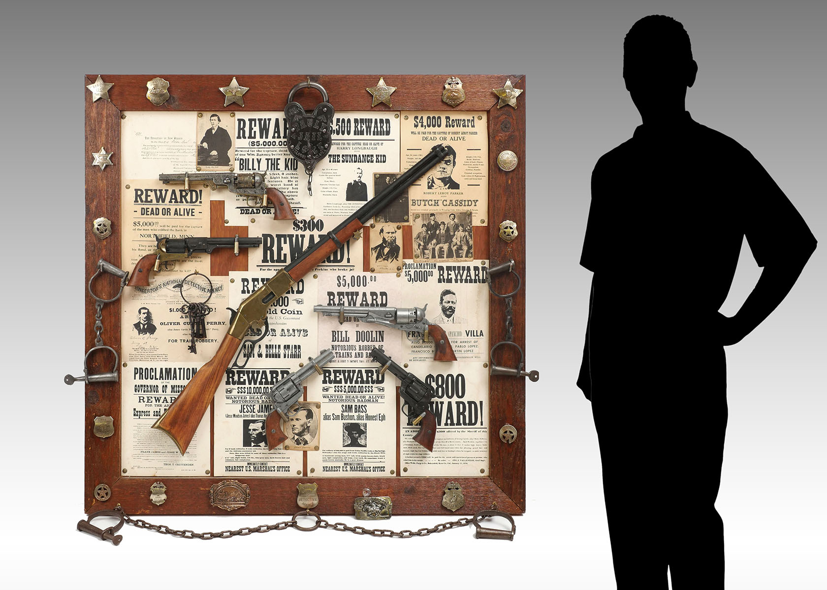 Appraisal: CONTEMPORARY LARGE OLD WESTERN WANTED POSTER GUN DISPLAY A most