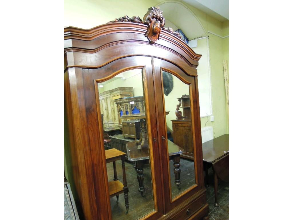 Appraisal: A th century mahogany armoire with arched and moulded pediment