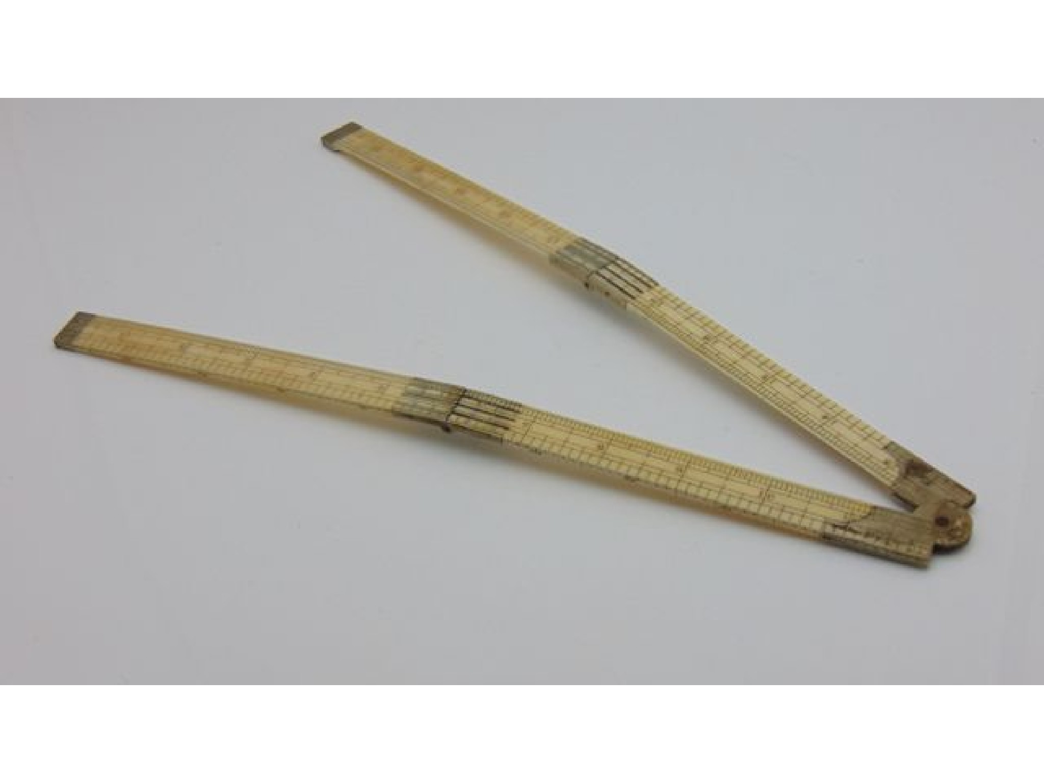 Appraisal: A Victorian ivory and steel mounted folding ruler to measure