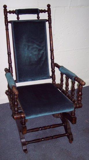 Appraisal: An American rocking chair the turned frame with upholstered back