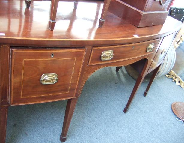 Appraisal: A George III mahogany and boxwood strung bowfront sideboard the