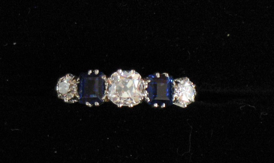 Appraisal: A FIVE STONE DIAMOND AND SAPPHIRE DRESS RING the two