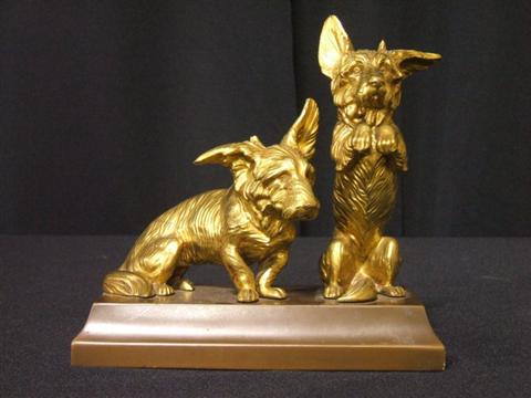 Appraisal: TWO GILT-METAL FIGURES OF DOGS Above a rectangular metal base