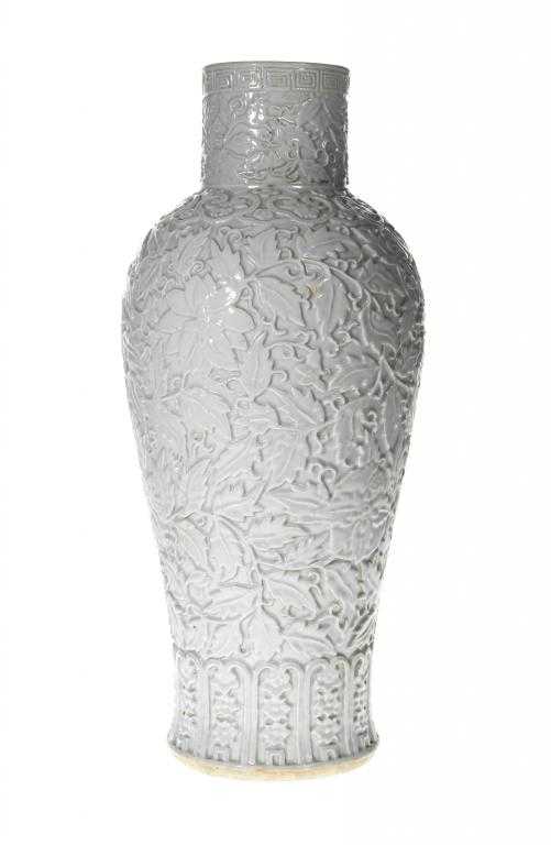 Appraisal: A CHINESE WHITE GLAZED AND CARVED PORCELAIN VASE of inverted