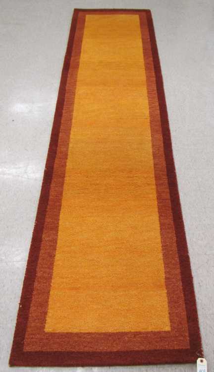 Appraisal: A CONTEMPORARY HAND KNOTTED RUNNER Indo-Gabbeh plain gold field with