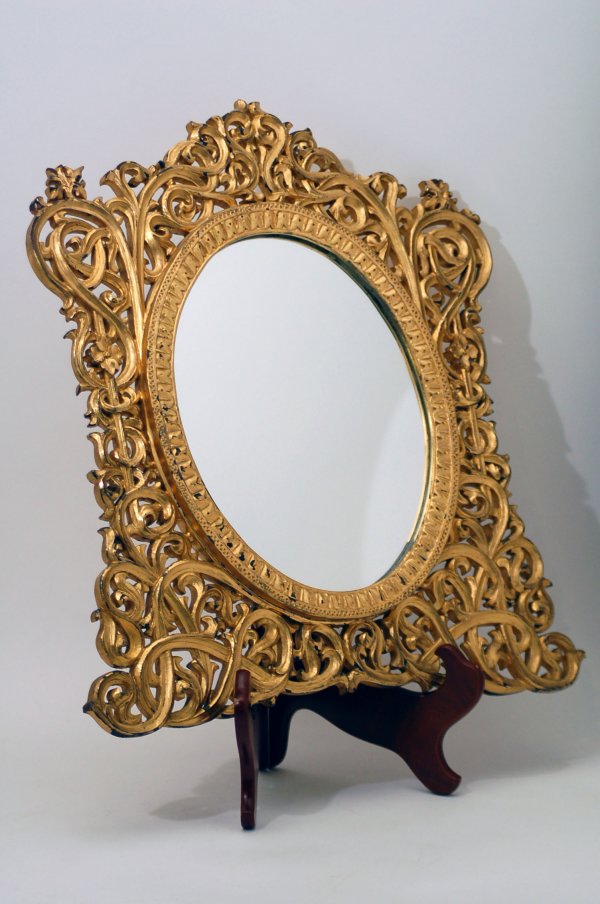 Appraisal: Wood and gilt frame oval opening with wide intricate scrolled