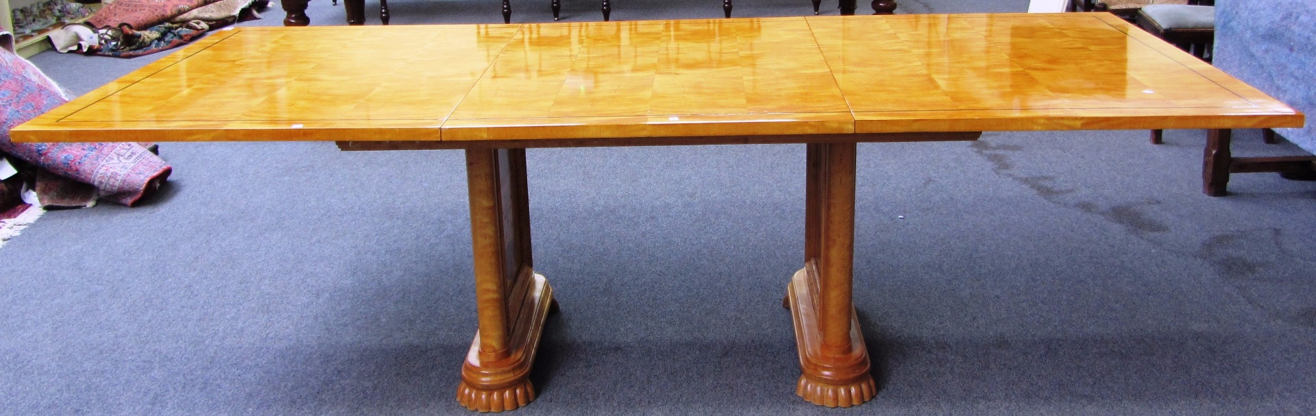 Appraisal: A Biedermeier style line inlaid satin birch extending dining table