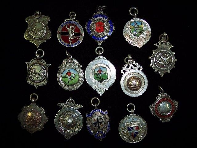 Appraisal: Two silver football medallions enamelled with players a similar running