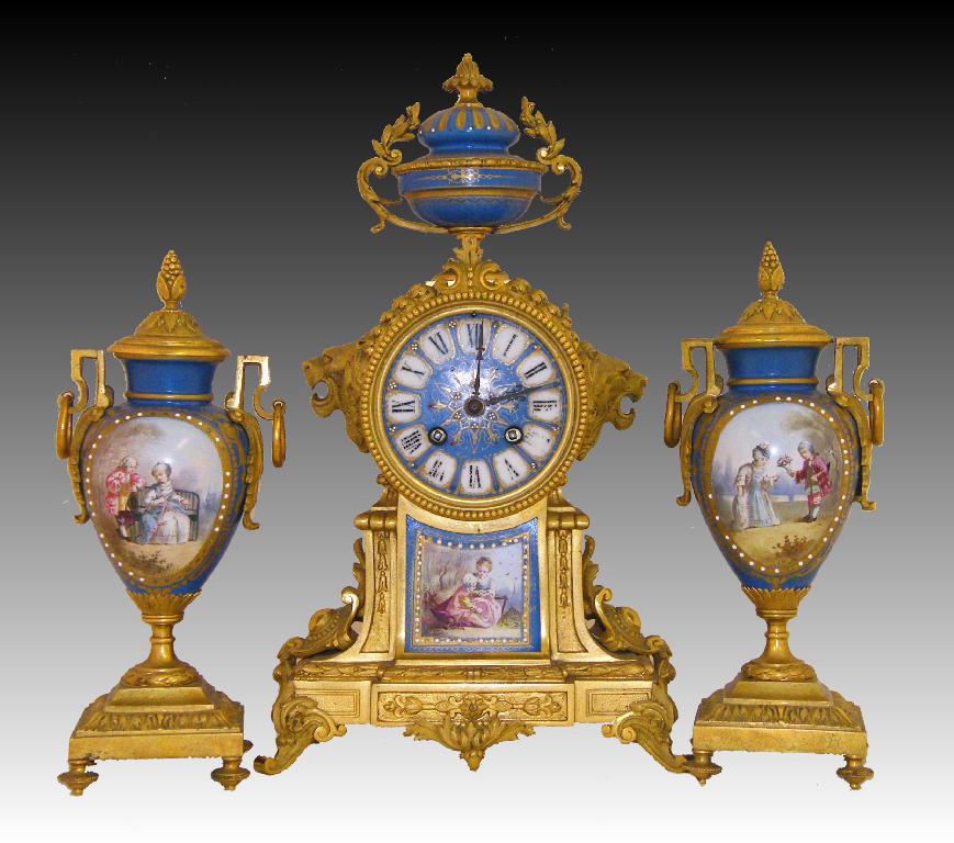 Appraisal: French porcelain and ormolu two train clock garniture the Japy