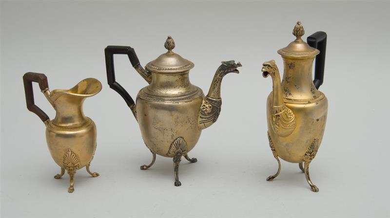 Appraisal: TWO EMPIRE SILVER-GILT INDIVIDUAL COFFEE POTS AND A MATCHING CREAMER