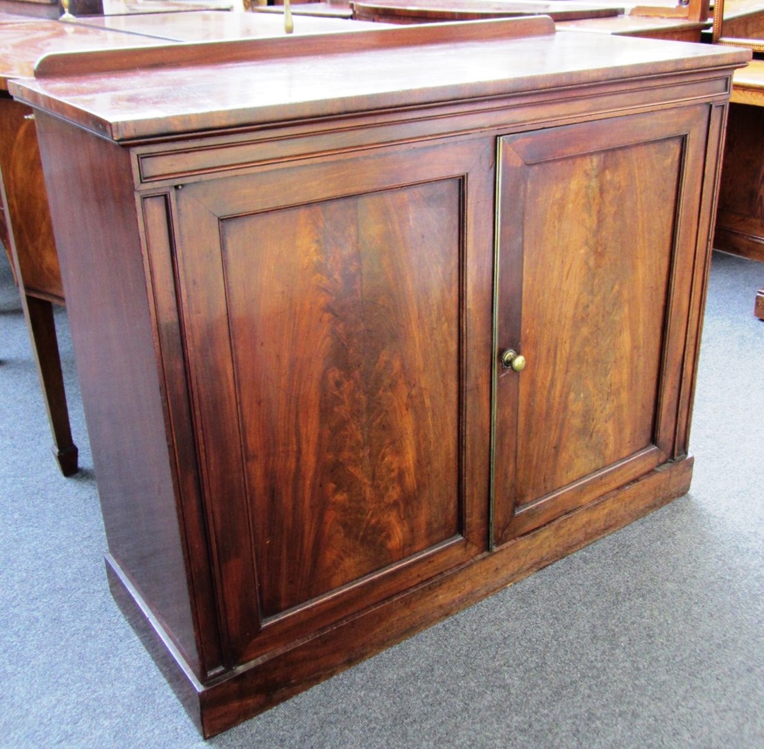 Appraisal: An early th century mahogany two door chiffonier plate warming