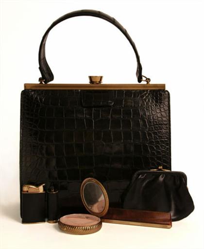 Appraisal: Black alligator purse s With an etched brass frame and