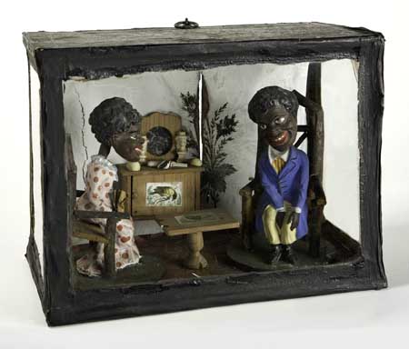 Appraisal: ART--FOLK ART Shadow box with two figures with bobble-heads seated