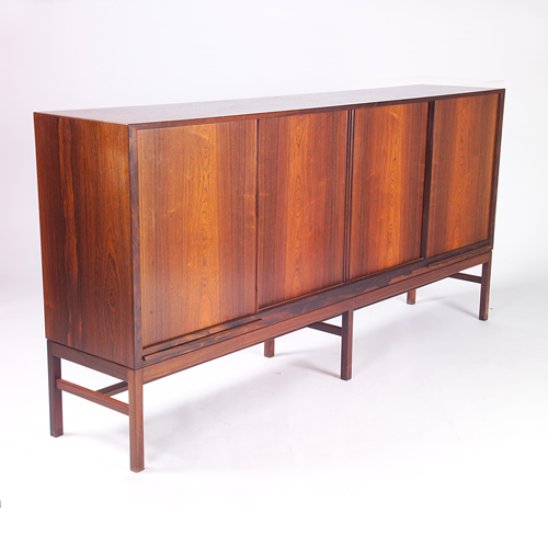 Appraisal: KURT OSTERVIG Fine rosewood buffet with four sliding doors concealing