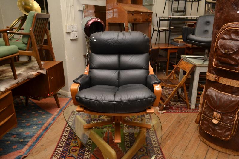 Appraisal: A TESSA BENTWOOD AND LEATHER ARMCHAIR ON A SWIVEL BASE