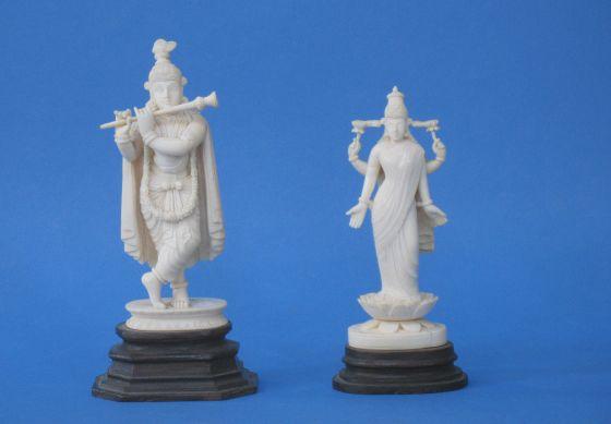 Appraisal: AN INDIAN IVORY FIGURE OF A DEITY on a hardwood