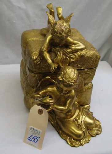 Appraisal: A GERMAN GILT METAL FIGURAL COVERED BOX with winged cherub