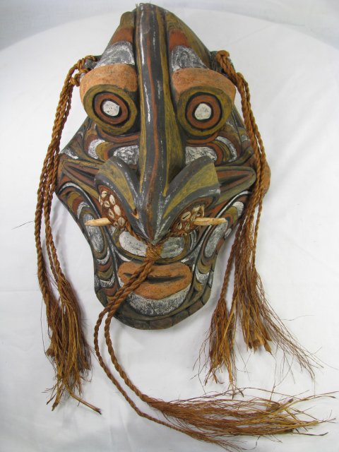 Appraisal: Large primitive carved and painted wood mask accented with straw