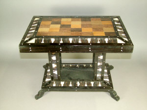 Appraisal: An Anglo Indian ebonised specimen topped and quillwork rectangular table