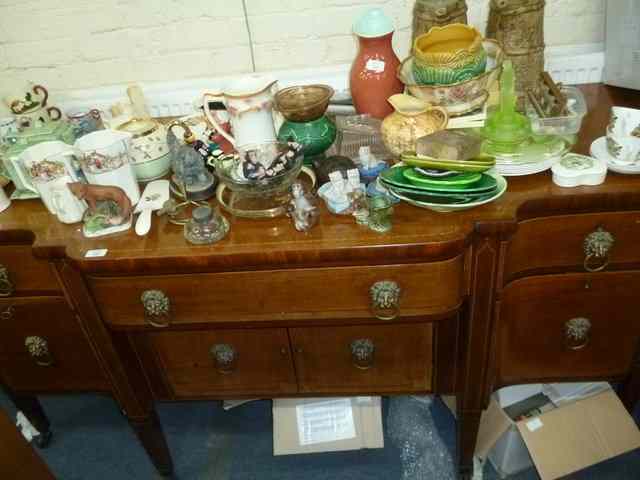 Appraisal: A GEORGIAN STYLE SERPENTINE FRONTED MAHOGANY SIDEBOARD the central bowed