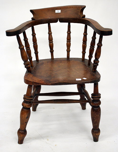 Appraisal: AN ELM SMOKERS BOW ARMCHAIR with turned spindle back and