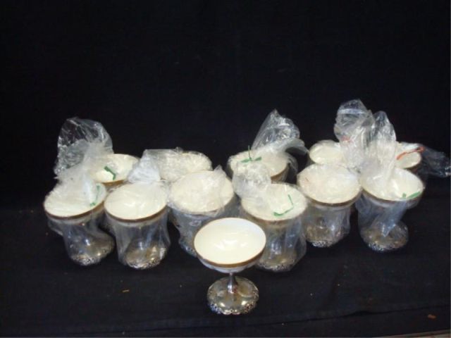 Appraisal: Sterling and Porcelain Cups Dimensions high Estimate -