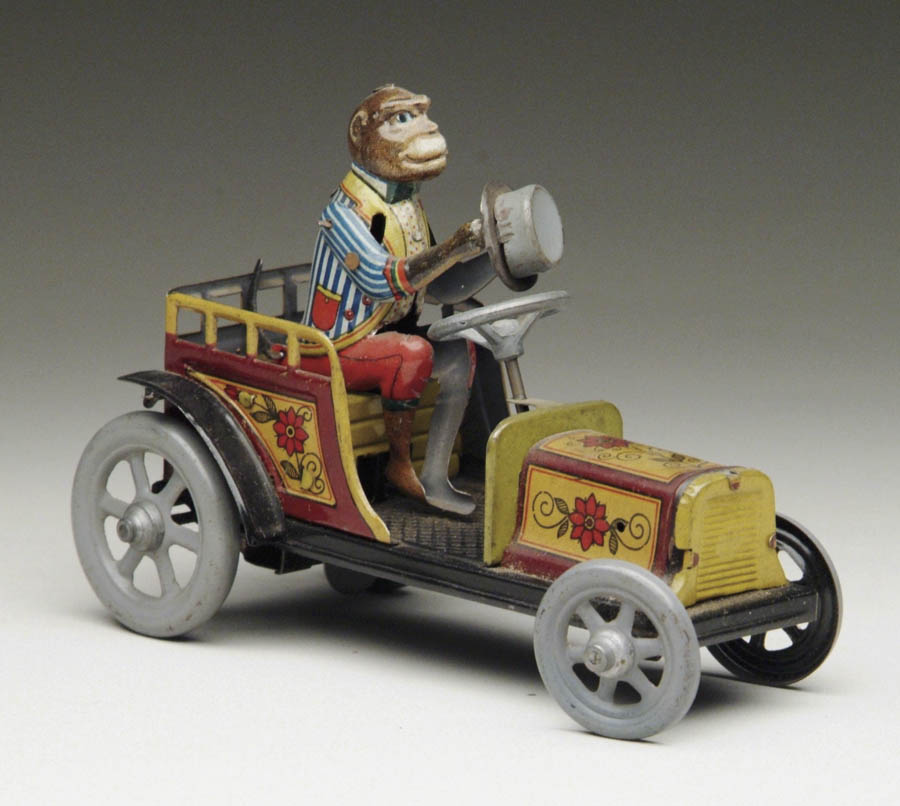 Appraisal: DISTLER WINDUP MONKEY CAR Brightly lithographed car with flowers being