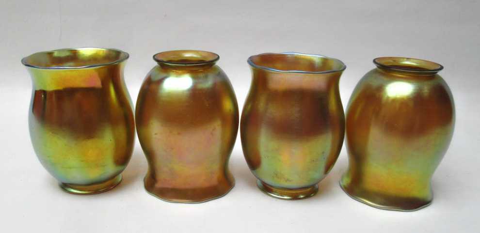 Appraisal: SET OF FOUR STEUBEN AURENE ART GLASS SHADES iridescent gold