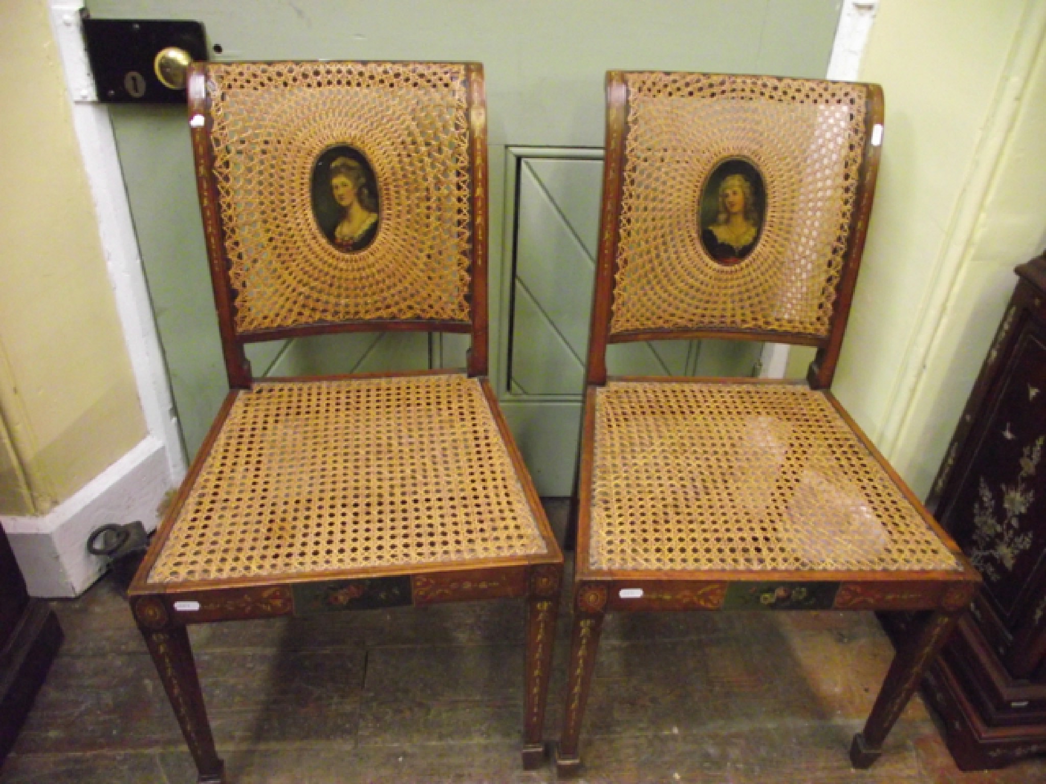 Appraisal: A pair of Edwardian side chairs with cane panelled seats