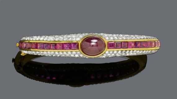 Appraisal: RUBY AND DIAMOND BANGLE Yellow gold Casual-elegant bangle the convex